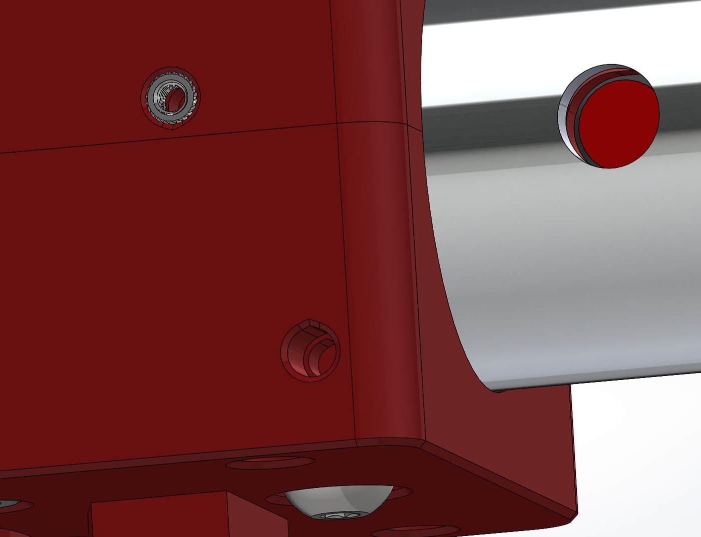 Close-up CAD render of a printed part showing a chamfered heat-set insert boss, a teardrop-shaped horizontal hole, and a chamfered bottom edge.
